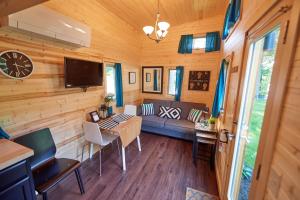 A television and/or entertainment centre at Tuxbury Pond Camping Resort Tiny House Emerson