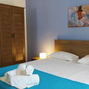 a bedroom with two towels on a bed at Neria Summer Houses in Hanioti