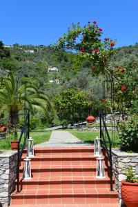a flight of stairs with red flowers and plants at SKIATHOS-FILOKALIA in Achladies