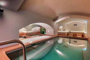 a large swimming pool in a room with a sink at Áurea Ana Palace by Eurostars Hotel Company in Budapest