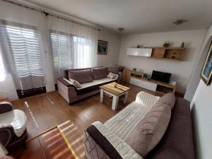 a living room with a couch and a table at Holiday Home Milanovic in Cetinje