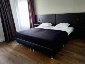 Postel nebo postele na pokoji v ubytování City Hotel Bergen op Zoom