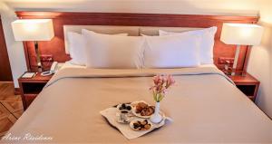 Voodi või voodid majutusasutuse Arève Résidence Boutique Hotel toas