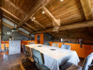 a dining room with a table and chairs and wooden ceilings at Appartement La Clusaz, 5 pièces, 8 personnes - FR-1-304-212 in La Clusaz