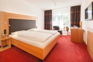 Postel nebo postele na pokoji v ubytování Hotel Der Achtermann