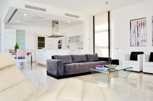 a living room with a couch and a table at Villas Opal Anfi Tauro in Mogán