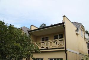 a balcony on the side of a house at Sunny 2BR with Balcony - 70m2 - 200m Beach in Jūrmala