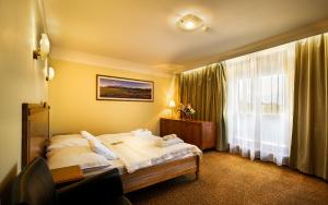 Posteľ alebo postele v izbe v ubytovaní Hotel International