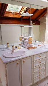 a bathroom with a sink and a mirror at Maison au cœur des Pyrénées in Perles-et-Castelet