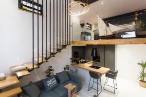 a living room with a blue couch and a desk at Castel Beachfront Apartment in Kaštela