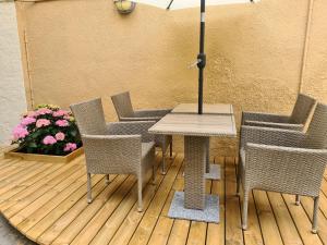 a table with chairs and an umbrella on a deck at Hotel Aarhus City Apartments in Aarhus
