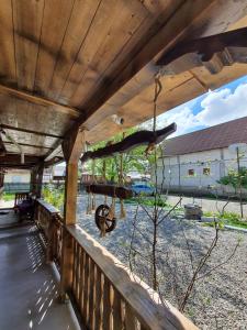 eine Veranda mit einem Holzzaun und Blick auf einen Hof in der Unterkunft La Romaneasa in Săpânța