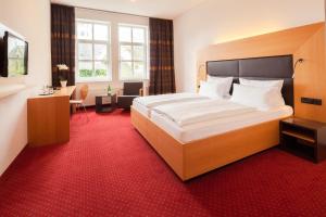 Postel nebo postele na pokoji v ubytování Hotel Der Achtermann