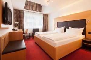 Postel nebo postele na pokoji v ubytování Hotel Der Achtermann