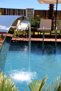 a water fountain in the middle of a swimming pool at Dmira Alacati in Alaçatı