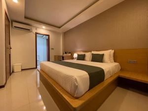 מיטה או מיטות בחדר ב-Huvan Beach Hotel at Hulhumale