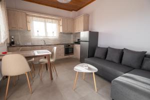a kitchen and a living room with a couch and a table at Fotini Apartments in Preveza