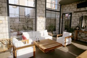 a living room with white furniture and a table at Dmira Alacati in Alaçatı
