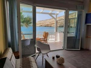 a living room with a couch and a view of the ocean at Nautilus in Matala