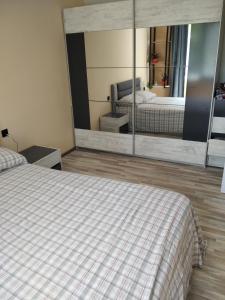 a bedroom with two beds and a large mirror at ТИХОТО МЯСТО in Burgas City