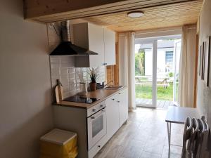 a kitchen with a sink and a stove top oven at Willa Bloom in Rewa