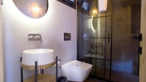 a bathroom with a toilet and a shower at Dmira Alacati in Alaçatı