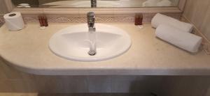 a bathroom sink with a faucet on a counter at La Mer Residence in Golden Sands