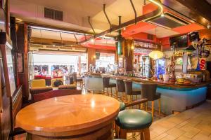 a bar with a wooden table and chairs at Rea Hotel in Faliraki