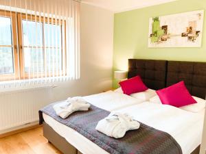 Ein Bett oder Betten in einem Zimmer der Unterkunft R&R Residenzen Aparthotel