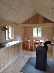 cocina y comedor de una cabaña de madera en Celoroční GLAMPING v pohodlném domečku, en Výprachtice