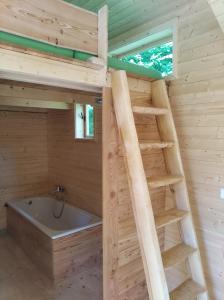 Cabaña de madera con escalera y bañera en Celoroční GLAMPING v pohodlném domečku, en Výprachtice