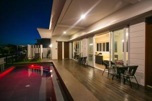 a house with a pool and a table and chairs at One Hagdan Villas in Boracay