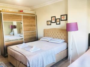 a small bedroom with a bed and a mirror at plt homes great home near the whaterfeal and beach cool location in Antalya