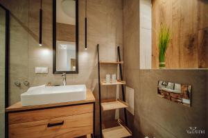 a bathroom with a sink and a mirror at Apartament Silence Karpatia Resort Zelda in Karpacz +22 photos