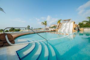 a large swimming pool with a water slide at Alannia Els Prats in Montroig
