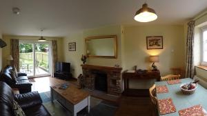 a living room with a couch and a fireplace at Signal Cottage at The Red House Estate in York