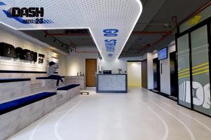 a man sitting on a counter in an office lobby at Dash 23 Hotel in Tainan