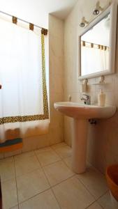 a bathroom with a sink and a window at Apartamentos San Vicente Playa in San Vicente de la Barquera