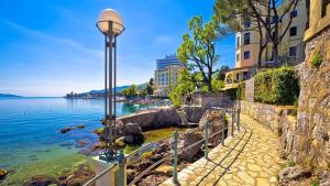 a street light next to a body of water at Apartman Manuela in Matulji