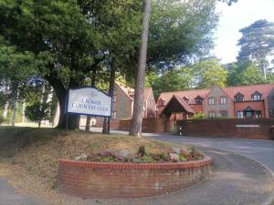 a sign for a community country club in front of a house at Clement's Retreat on the North Norfolk Coast in Cromer
