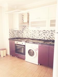 a kitchen with a washing machine and a sink at Trabzon Meydan in Trabzon