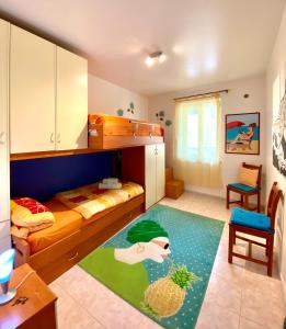 a small room with a bunk bed and a rug at Apartments Villa Kristina in Forza dʼAgro