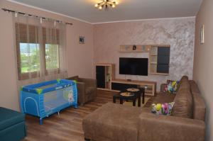 a living room with a couch and a toy crib at Babakaj in Golubac