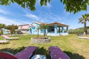 a villa with a garden and a house at Villa Amorossa with Garden View & Shared Pool by Konnect, Roda Corfu in Roda