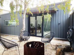 a group of chairs and a tree in a yard at The Birch Studio - BOUTIQUE ACCOMODATION - CENTRAL to WINERIES and BEACHES in Leopold