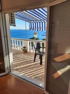 a room with a view of the ocean from a balcony at Apartments Marijana in Zavalatica