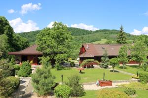 a house with a garden in front of a building at Dukla Ranč in Nižný Komárnik