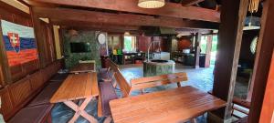 a room with two wooden benches and a kitchen at Dukla Ranč in Nižný Komárnik