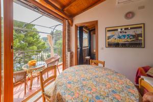 a room with a balcony with a table and chairs at ToviMar Apartments in Taormina