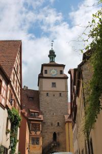 a building with a clock tower in a city at Gasthof Butz in Rothenburg ob der Tauber
